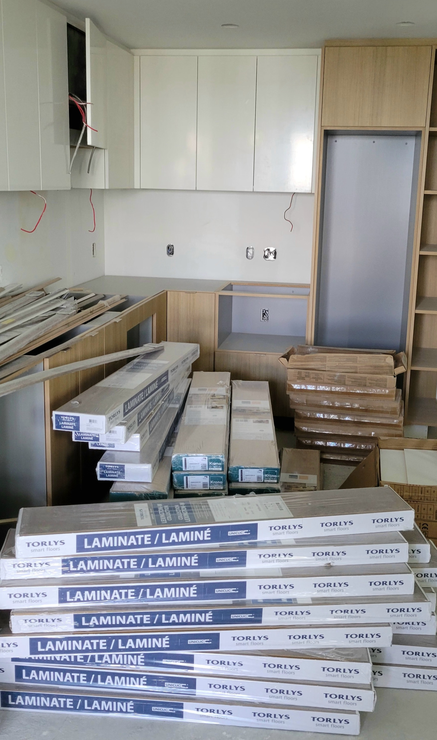 Kitchen under renovation, full of construction and renovation materials.