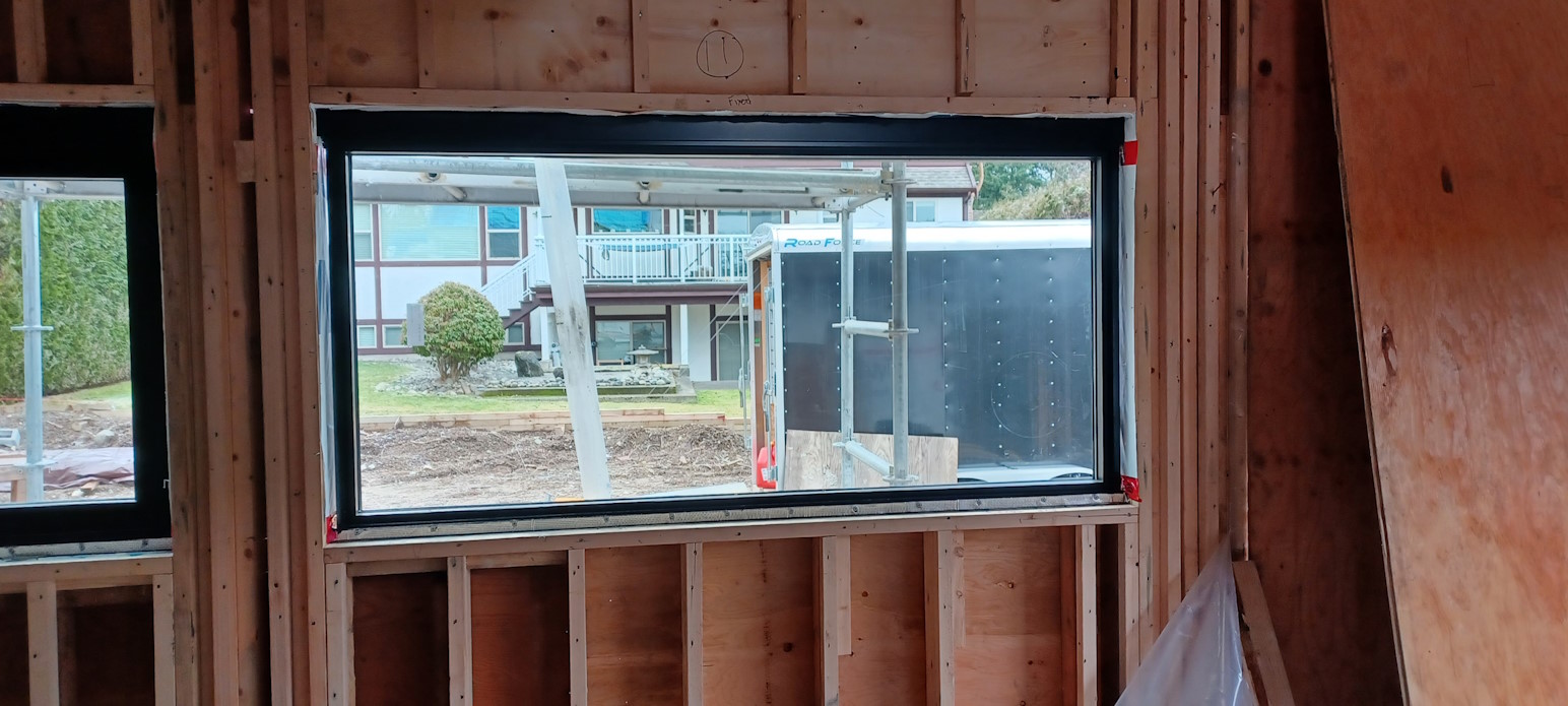 An installed window in a house construction project.