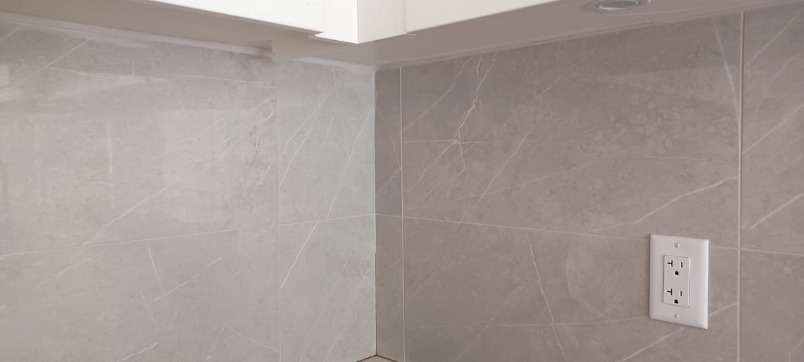 A close up on the installed kitchen corner wall tiles.