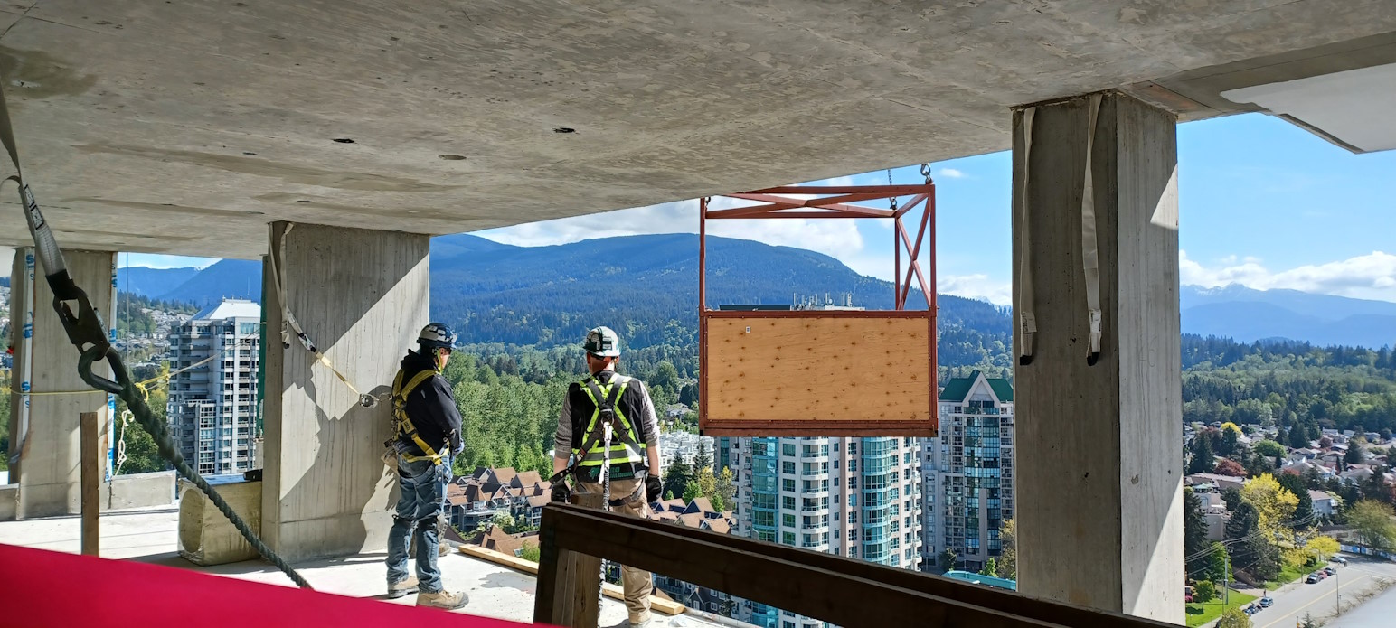 Two construction contractors standing over the city skyline.