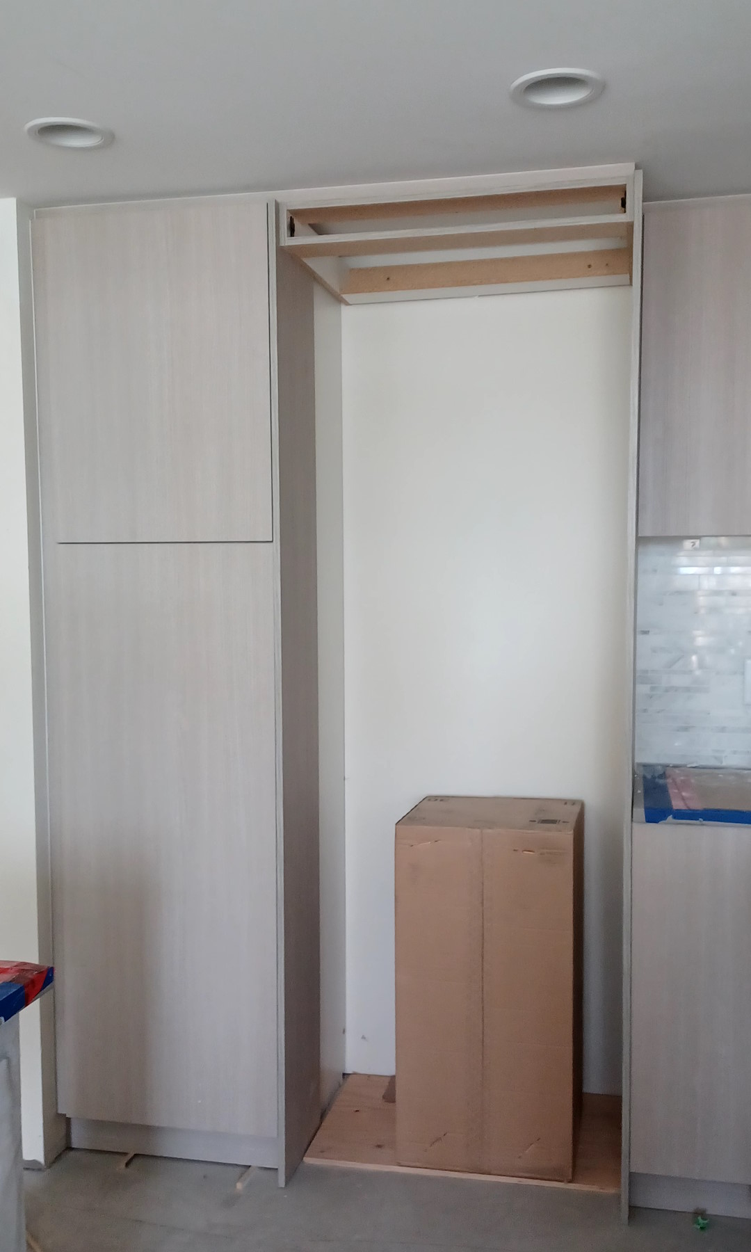 Newly-installed allegiant wooden kitchen cabinets and kitchen closet.