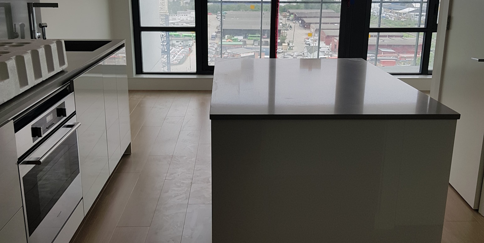 Renovated kitchen counters and drawers, with new hardwood flooring.