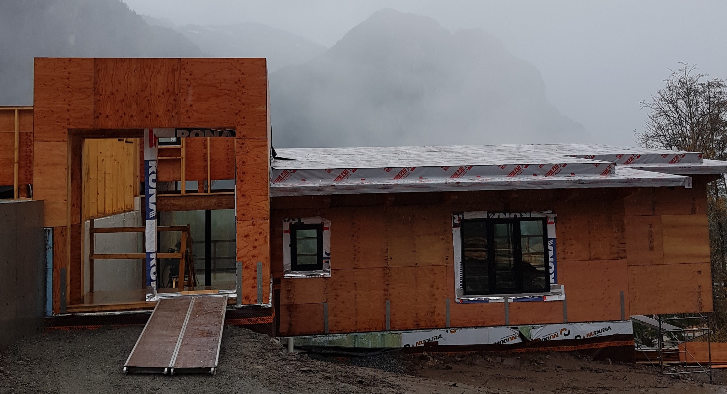 A house under construction, with new installed windows.