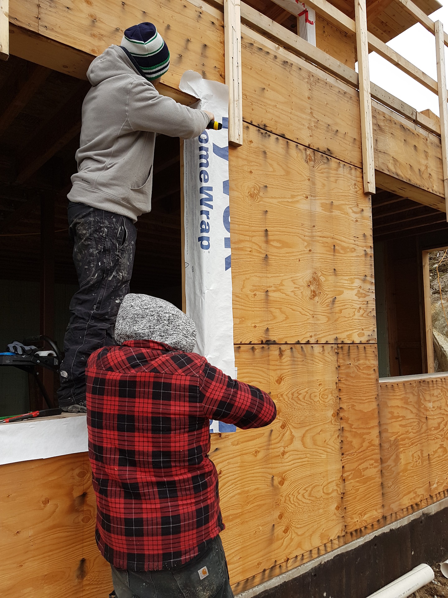 Glazgo Global Construction contractors installing windows in a newly-built house.
