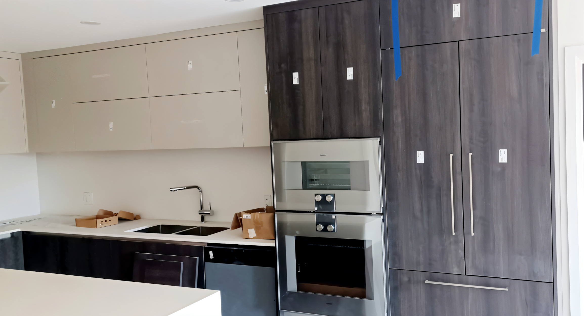 A kitchen renovated at UBC, with installed kitchen cabinets, wall tiles, and counters.