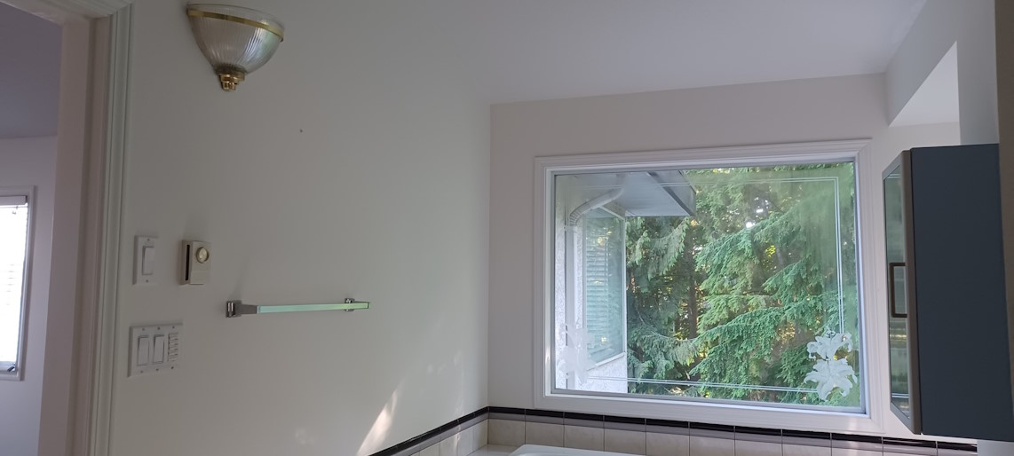 Final result of bathroom renovation, with bright newly-painted walls.