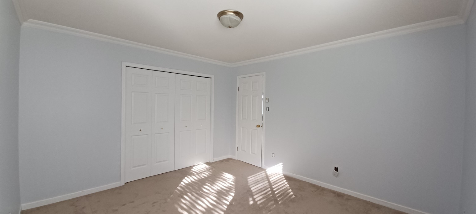 A bright renovated bedroom after being painted.