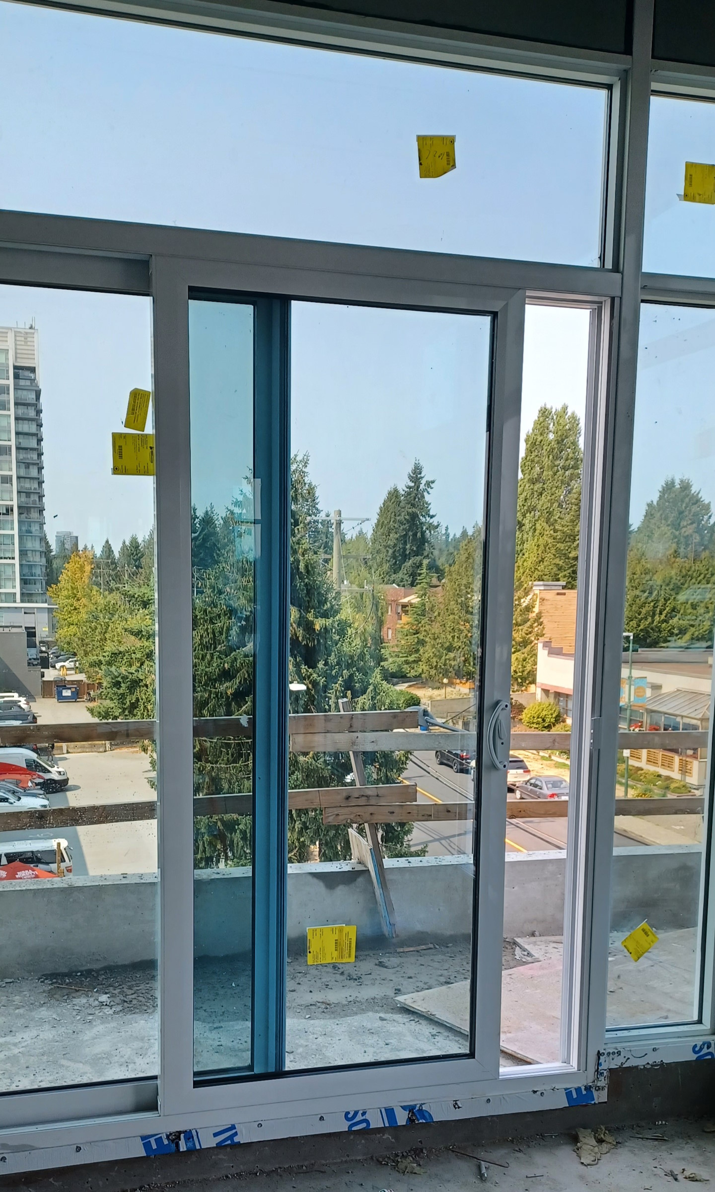 An installed sliding glass door leading out to an apartment balcony.